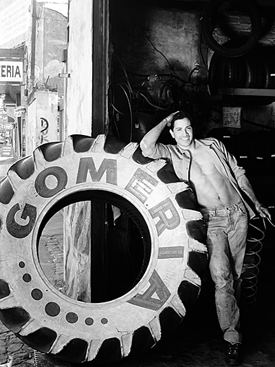 Man leaning on big tire